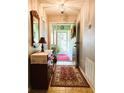 Inviting entryway featuring tile floors, decorative mirror, and a view into the bright sunroom at 3579 Sw Shorewood Dr, Dunnellon, FL 34431