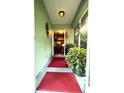 Inviting entryway with a red mat and tasteful decorations, leading to a glimpse of the elegant interior at 3579 Sw Shorewood Dr, Dunnellon, FL 34431
