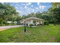 Charming single story home with an attached garage and lush lawn at 3579 Sw Shorewood Dr, Dunnellon, FL 34431