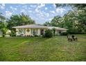 Charming home with a large front yard and decorative shutters at 3579 Sw Shorewood Dr, Dunnellon, FL 34431