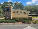 Saddlecreek 2 community sign surrounded by stone accents and lush landscaping at 3918 Sw 57Th Ave, Ocala, FL 34474