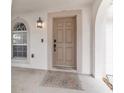 Covered front porch with decorative door rug and updated light fixture near the front door at 4624 Se 32Nd Pl, Ocala, FL 34480
