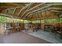 Outdoor gazebo complete with bar, stools, comfortable seating, and unique wood ceiling at 4710 Se 30Th Ct, Ocala, FL 34480