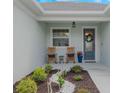 Cozy front porch with rocking chairs, decorative plants, and a stylish front door at 4743 Nw 11Th Ct, Ocala, FL 34475
