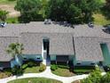 Aerial view of condo featuring a well-maintained roof, landscaping, and nearby foliage at 606 Midway Dr # B, Ocala, FL 34472