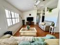 Inviting living room with hardwood floors, comfortable couches, and plantation shutters at 6070 Sw 98Th Loop, Ocala, FL 34476