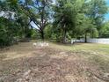 Large backyard with ample space, including a fire pit area and fenced perimeter at 6306 Pecan Crse, Ocala, FL 34472
