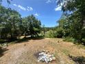 Expansive backyard featuring mature trees and ample space for outdoor activities at 6498 Se 167Th Ct, Ocklawaha, FL 32179