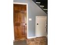 Inviting entryway showcasing a traditional wood door, tile flooring, and staircase access at 6498 Se 167Th Ct, Ocklawaha, FL 32179
