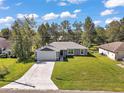 Inviting single-story home with a spacious lawn, long driveway, and a well-maintained facade at 6730 Cherry Rd, Ocala, FL 34472