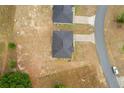Aerial view of two homes with dark roofs and expansive yards in a suburban neighborhood at 69 Juniper Trail Loop, Ocala, FL 34480