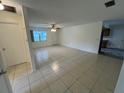 Open-concept living room with tile flooring, natural lighting, and a ceiling fan at 8654 Sw 96Th St # D, Ocala, FL 34481