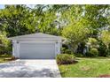 Inviting single-story home with a two-car garage, well-maintained lawn, and manicured landscaping at 9565 Sw 194Th Cir, Dunnellon, FL 34432