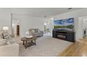 Bright living room featuring a modern fireplace, neutral décor, and seamless flow to the foyer at 9565 Sw 194Th Cir, Dunnellon, FL 34432