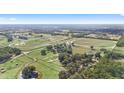 Expansive equestrian property with tracks and stables surrounded by a lush landscape at Lot 8,9,10 Ne 155Th Pl, Citra, FL 32113