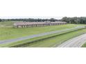 Spacious horse barn with adjacent track and expansive green pastures, perfect for equestrian pursuits at Lot 8,9,10 Ne 155Th Pl, Citra, FL 32113