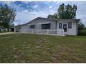 Charming single-story home with a carport, gray exterior, and a well-maintained front yard at 10330 Sw 99Th Ave, Ocala, FL 34481