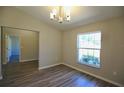 Bright room with wood-look floors, chandelier, and a window providing natural light at 11609 Sw 59Th Ter, Ocala, FL 34476