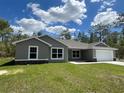 Charming single-story home with a well-manicured lawn and attached two-car garage at 12953 Sw 85Th Pl, Dunnellon, FL 34432