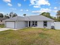 Charming single-story home with a well-manicured lawn and an attached garage with driveway at 14118 Sw 32Nd Terrace Rd, Ocala, FL 34473