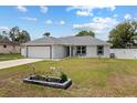 Charming single-story home with an attached garage, meticulous lawn, and cute flower bed at 14118 Sw 32Nd Terrace Rd, Ocala, FL 34473