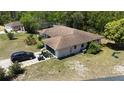Aerial view of a single-story home featuring a brown roof, screened in lanai, and black SUV at 15920 Sw 49Th Court Rd, Ocala, FL 34473