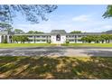 Exterior view of the charming condo building with well-maintained landscaping and ample parking space at 1640 Ne 40Th Ave # 107, Ocala, FL 34470