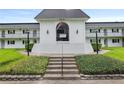 Exterior of the entrance to Silver Pines showing the stairs leading up to an arched entrance and American flag at 1640 Ne 40Th Ave # 107, Ocala, FL 34470