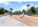 Sprawling estate featuring lush landscaping, a circular driveway, and multiple garage spaces at 170 Sw 80Th St, Ocala, FL 34476