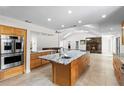 Open-concept kitchen featuring a large island with granite countertops and stainless steel appliances at 170 Sw 80Th St, Ocala, FL 34476