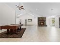 Spacious living room features a pool table, stone fireplace, and vaulted ceilings at 170 Sw 80Th St, Ocala, FL 34476