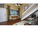 Bright living room featuring a desk area, staircase, and an open layout with natural light at 20820 River Dr # B32, Dunnellon, FL 34431