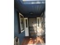 Covered front porch with brick flooring, white trim, and a classic front door at 2151 Se 177Th Ave, Silver Springs, FL 34488