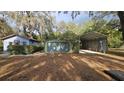 View of detached garages and carport with mature foliage at 2151 Se 177Th Ave, Silver Springs, FL 34488