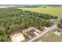 Beautiful aerial view of home surrounded by lush green trees at 23131 Sw Rainelle Rd, Dunnellon, FL 34431