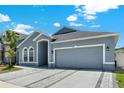 Attractive home features a two-car garage, neat landscaping, and inviting entryway at 2525 Sand Arbor Cir, Orlando, FL 32824