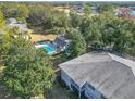 Gorgeous aerial view featuring a refreshing community pool, lush trees and golf course in the background at 588 Fairways Ln # E204, Ocala, FL 34472