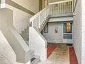 Exterior condo entryway with concrete steps leading to upper-level units and neatly maintained landscaping at 588 Fairways Ln # E204, Ocala, FL 34472