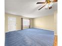 Bright living room featuring neutral paint, plush carpeting and a large window overlooking the front yard at 6263 Sw 107Th St, Ocala, FL 34476