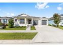 Beautiful single-story home with a covered porch, lush lawn, and convenient two-car garage at 6342 Sw 77Th Ave, Ocala, FL 34474