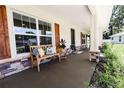 Inviting front porch with stone accents, cozy seating, and decorative shutters offering a relaxing outdoor space at 6600 Sw 109Th Ln, Ocala, FL 34476