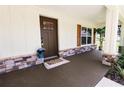 Charming front porch boasts stone accents, a colorful welcome mat, and a secure front door at 6600 Sw 109Th Ln, Ocala, FL 34476