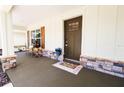 Inviting front porch with stone accents, wooden shutters, and a welcoming entrance at 6600 Sw 109Th Ln, Ocala, FL 34476