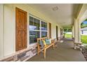 Inviting front porch with seating, decorative pillows, and stylish wood shutters at 6600 Sw 109Th Ln, Ocala, FL 34476