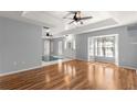 Bright and airy living room with hardwood floors, tray ceiling, and a large bay window at 6758 Sw 114Th Street Rd, Ocala, FL 34476