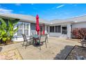 Cozy backyard patio area, perfect for outdoor dining with a table and umbrella at 6758 Sw 114Th Street Rd, Ocala, FL 34476