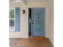 Close up of the front door with decorative details, window and adjacent sidelight at 8130 Sw 209Th Court Rd, Dunnellon, FL 34431