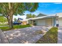 Street view of a well-maintained home with a two-car garage and a concrete driveway at 8569 Sw 92Nd Ln # D, Ocala, FL 34481