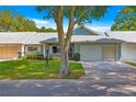 Inviting single-story home with a well-manicured lawn, and an attached two-car garage at 8569 Sw 92Nd Ln # D, Ocala, FL 34481