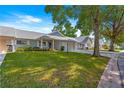 Well-maintained homes with green lawns, attached garages, and mature shade trees at 8569 Sw 92Nd Ln # D, Ocala, FL 34481